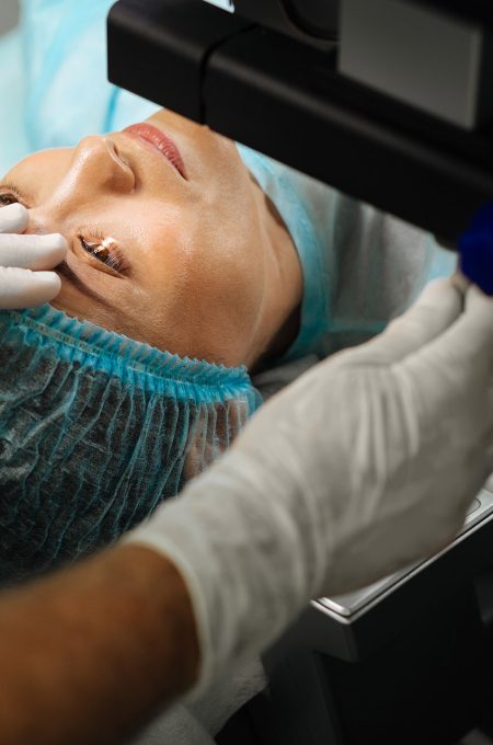 Nice adult woman lying on the medical bed while having a laser treatment procedure